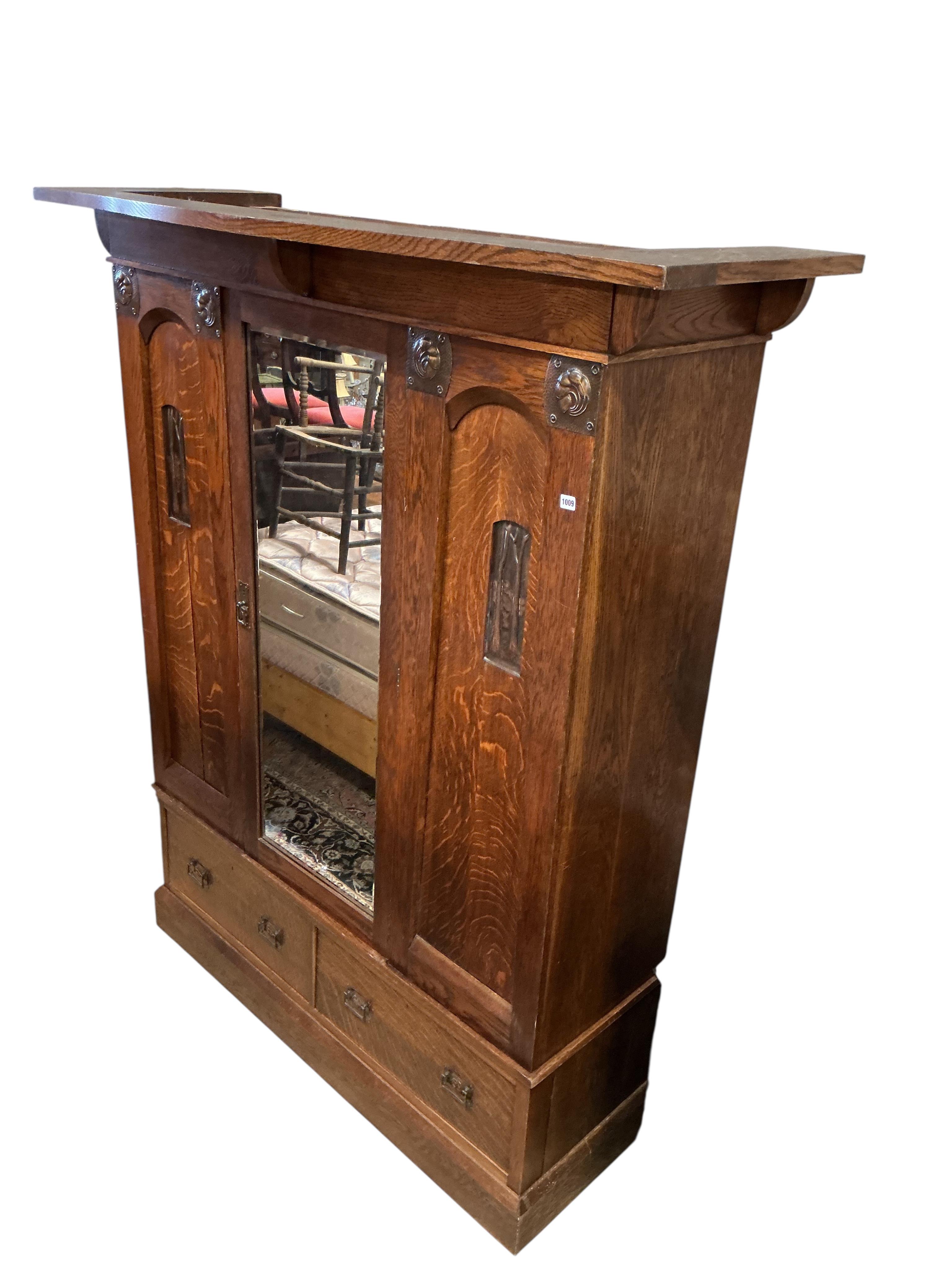 An Arts and Crafts copper mounted oak wardrobe in the manner of Shapland & Petter, width 176cm, depth 65cm, height 209cm